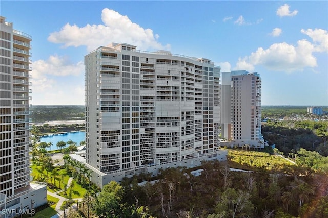 view of building exterior with a view of city and a water view