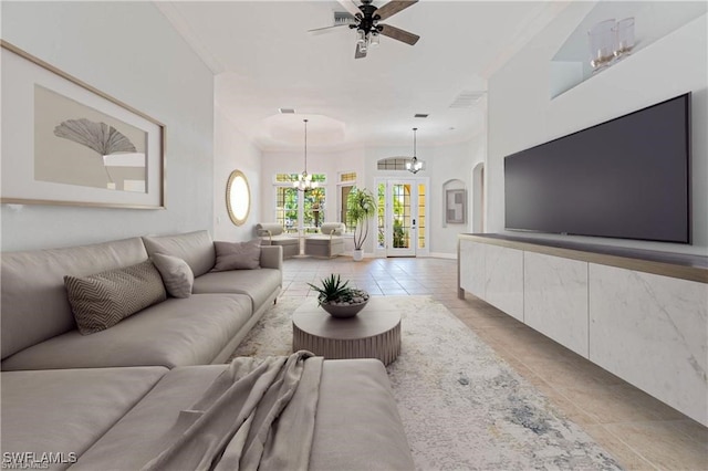 tiled living room featuring ceiling fan with notable chandelier and ornamental molding