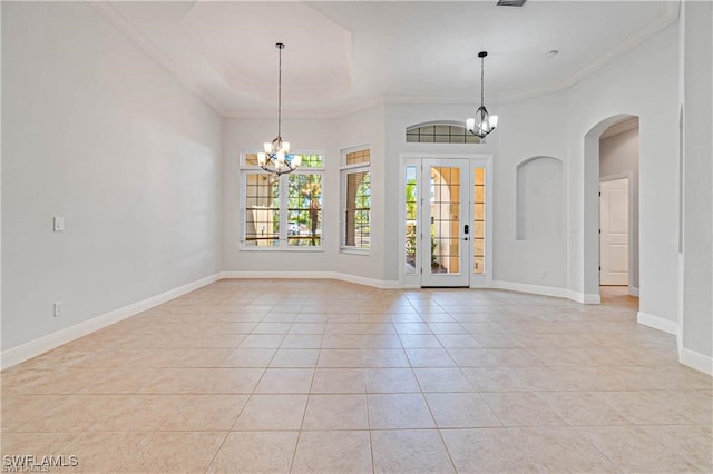 tiled spare room featuring crown molding and an inviting chandelier