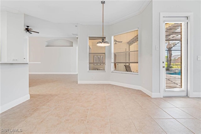 unfurnished dining area featuring ornamental molding, ceiling fan, and light tile patterned floors