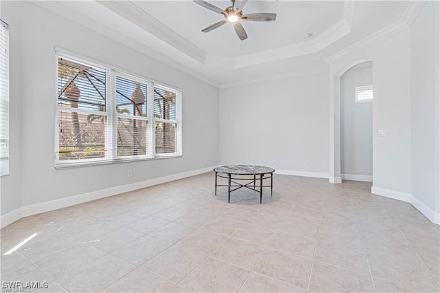 unfurnished room featuring ceiling fan, crown molding, a tray ceiling, and light tile patterned floors