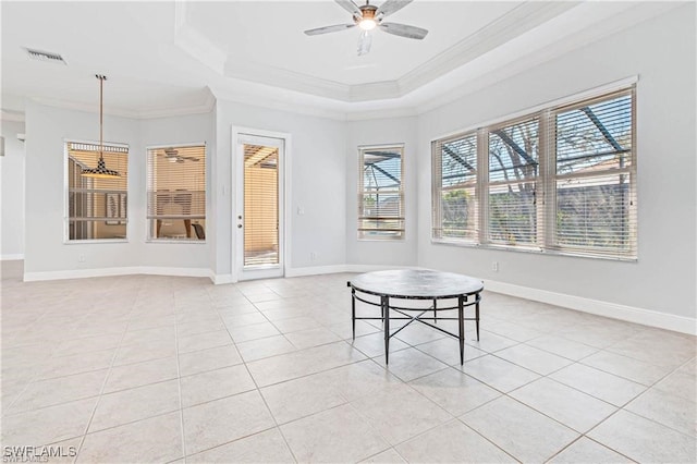 interior space with a tray ceiling, crown molding, and ceiling fan