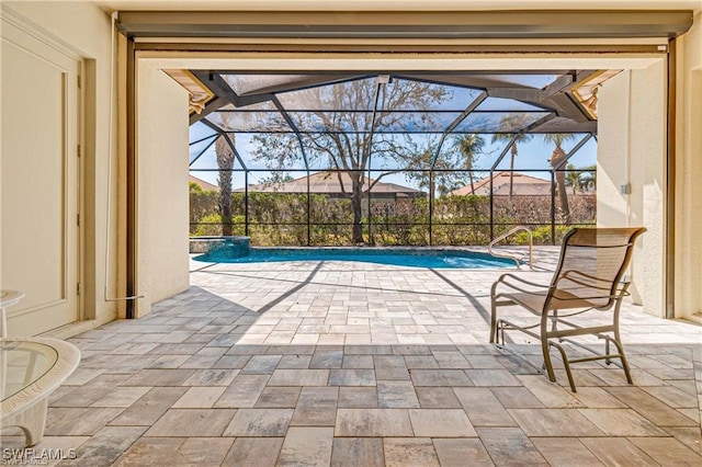 view of pool featuring glass enclosure and a patio area