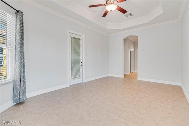 spare room featuring ornamental molding, ceiling fan, and a raised ceiling