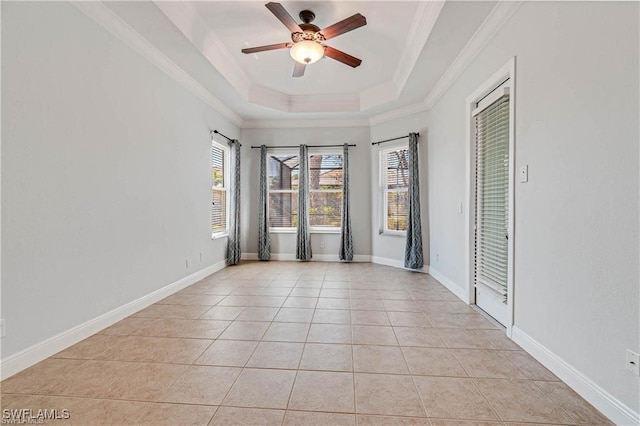 tiled spare room with ceiling fan, a raised ceiling, and ornamental molding