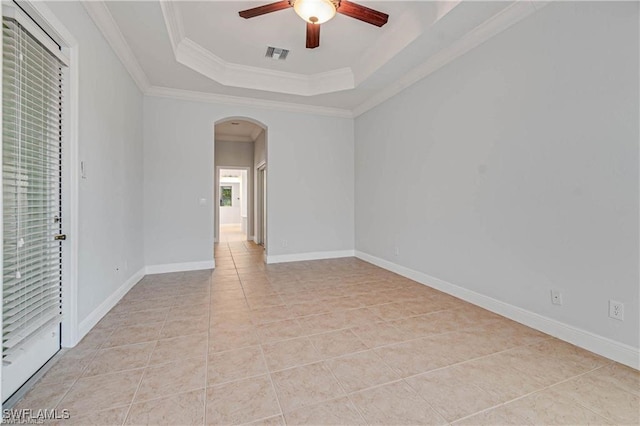 tiled spare room with crown molding, ceiling fan, and a tray ceiling