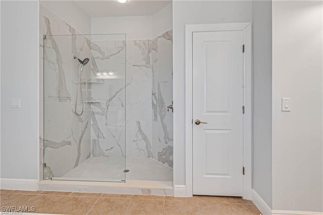 bathroom with tile patterned flooring and tiled shower