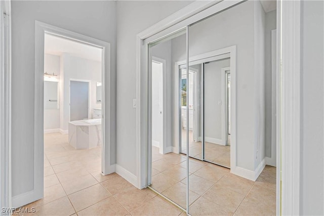 hall featuring light tile patterned floors