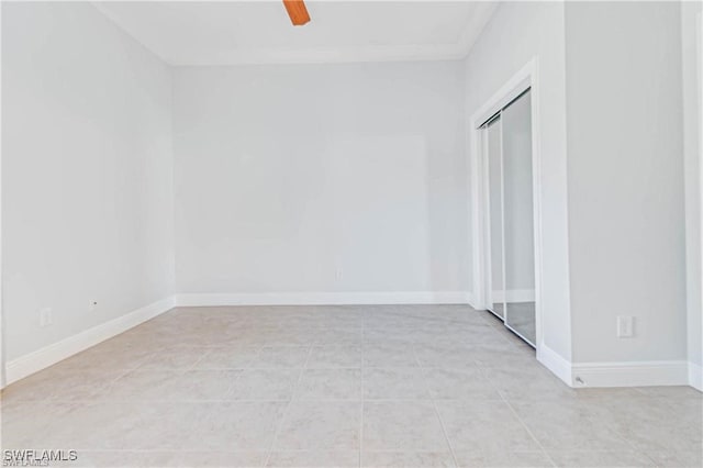 tiled empty room with ceiling fan