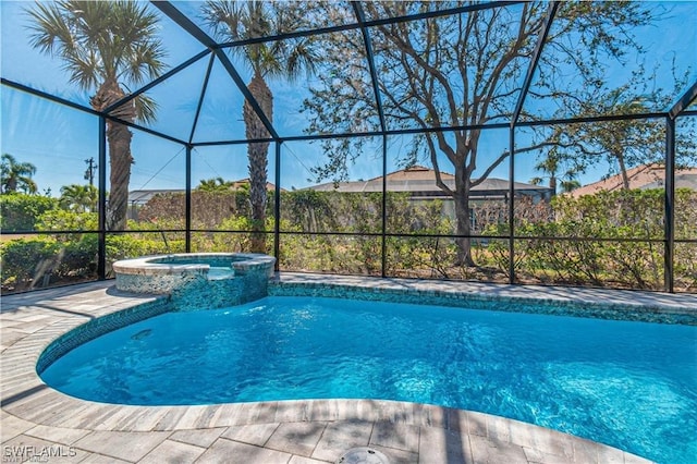 view of pool featuring an in ground hot tub and glass enclosure