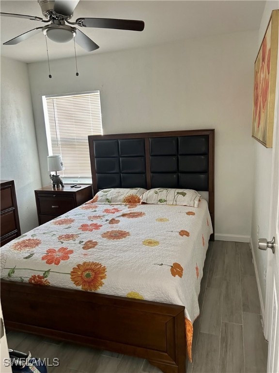 bedroom with ceiling fan and hardwood / wood-style floors