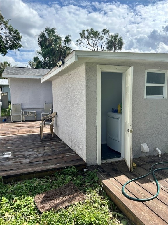 exterior space with washer / dryer and a wooden deck