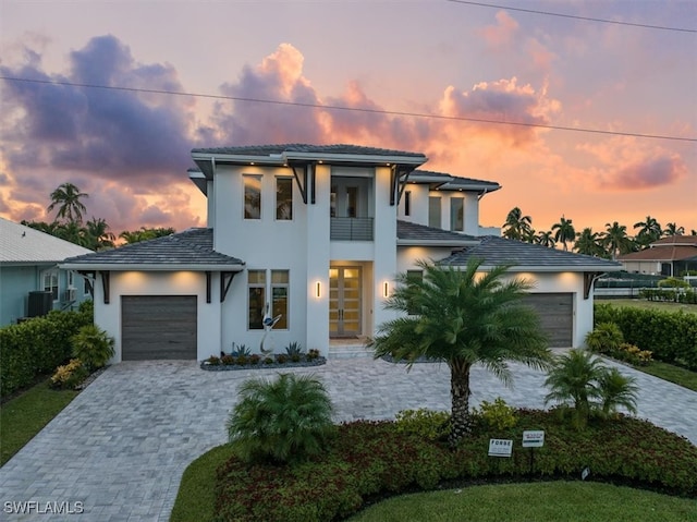 prairie-style home featuring a balcony and a garage