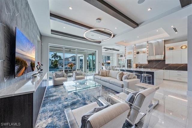 living room with beamed ceiling and sink