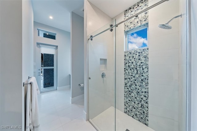 bathroom featuring tile patterned floors and a shower with door