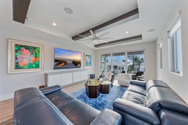 living room with ceiling fan, beam ceiling, and light hardwood / wood-style floors