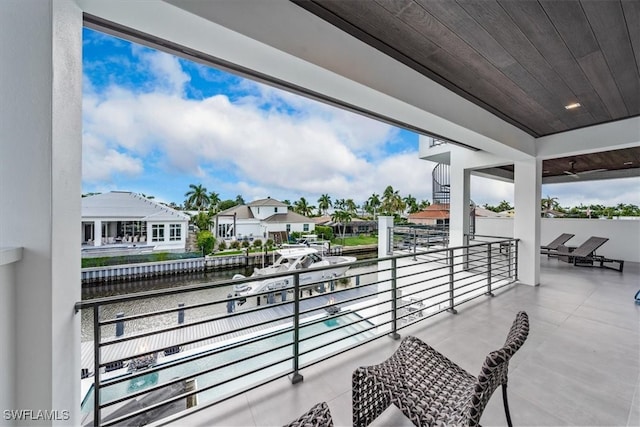 view of patio with a water view and a balcony