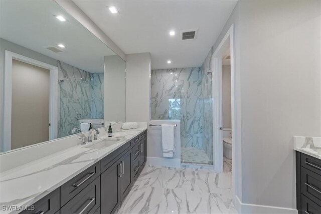 bathroom with vanity, tile walls, toilet, and a shower with shower door