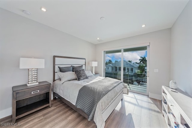 bedroom featuring access to outside and light hardwood / wood-style floors