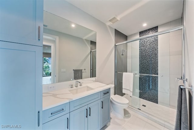 bathroom featuring walk in shower, vanity, tile patterned flooring, and toilet