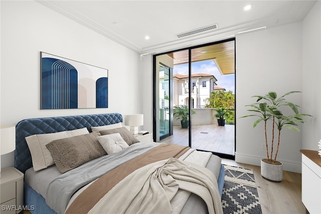 bedroom with access to outside and light hardwood / wood-style flooring