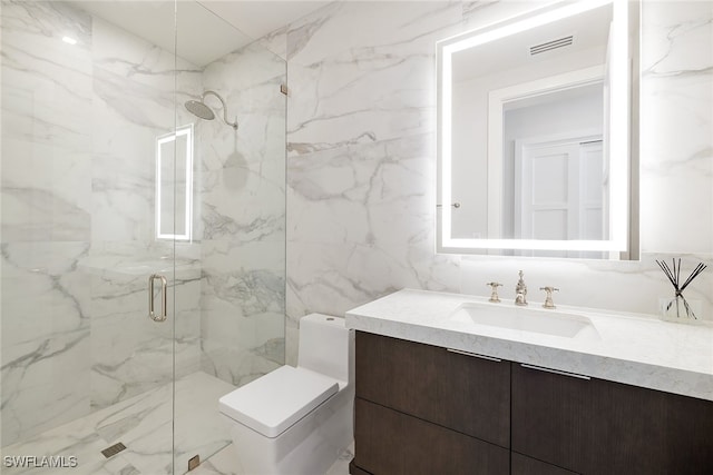 bathroom featuring tile walls, a shower with shower door, vanity, and toilet