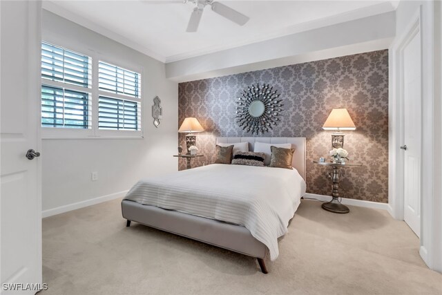 carpeted bedroom featuring ornamental molding and ceiling fan