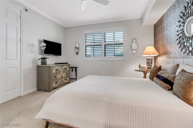 carpeted bedroom featuring ornamental molding and ceiling fan