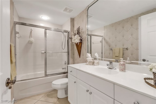 full bathroom featuring vanity, enclosed tub / shower combo, toilet, and tile patterned flooring