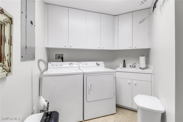 washroom with cabinets, electric panel, separate washer and dryer, light tile patterned flooring, and sink