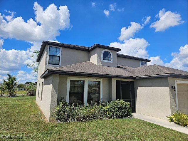 view of front of property featuring a garage and a front lawn