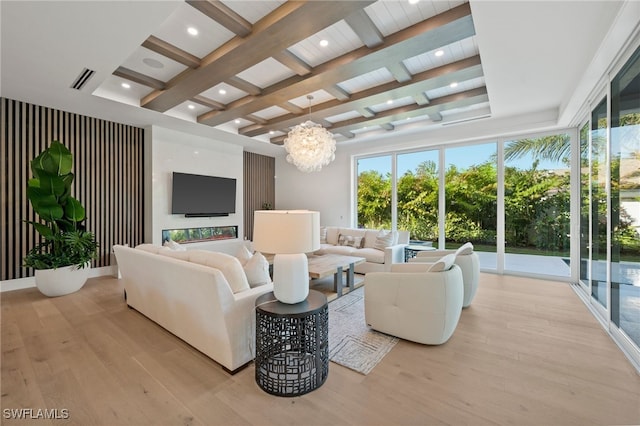 living room featuring beam ceiling, light hardwood / wood-style floors, coffered ceiling, and a notable chandelier