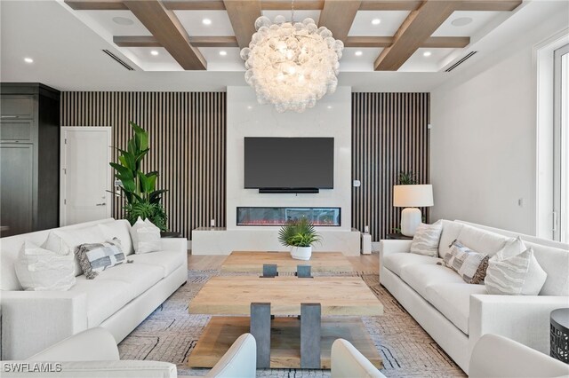 living room featuring a chandelier, beam ceiling, and coffered ceiling