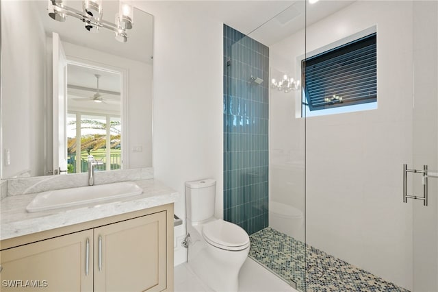 bathroom with an enclosed shower, ceiling fan, toilet, and vanity