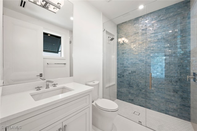 bathroom featuring vanity, an enclosed shower, and toilet