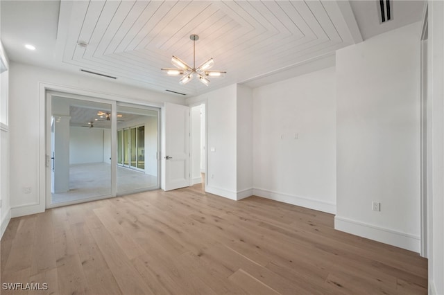 empty room with hardwood / wood-style floors, wood ceiling, and an inviting chandelier