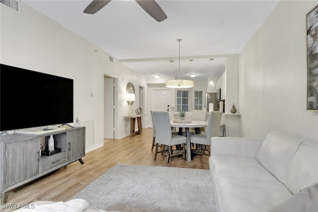 living room with light wood-type flooring and ceiling fan