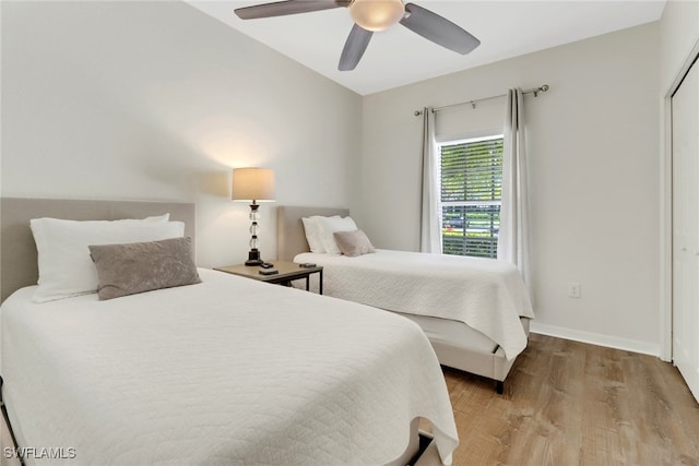 bedroom with ceiling fan and light hardwood / wood-style floors