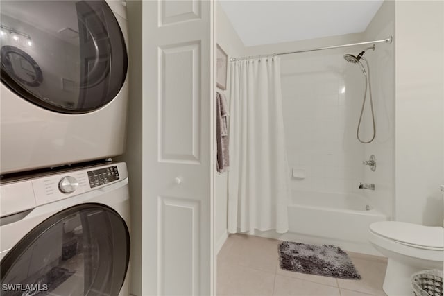 laundry room featuring light tile patterned floors and stacked washer and dryer