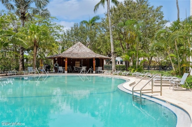 community pool with a patio area and a gazebo