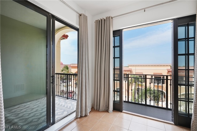 doorway to outside featuring light tile patterned flooring