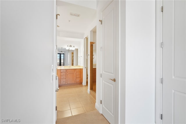 hall featuring light tile patterned floors