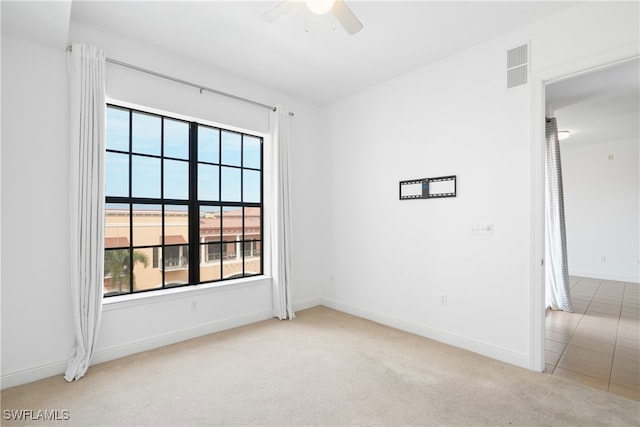 carpeted empty room featuring ceiling fan