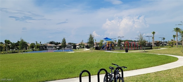 view of community with a playground and a lawn