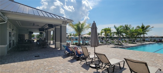 view of pool with a patio and ceiling fan