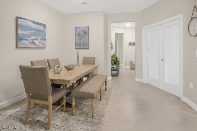 dining area with light tile patterned floors