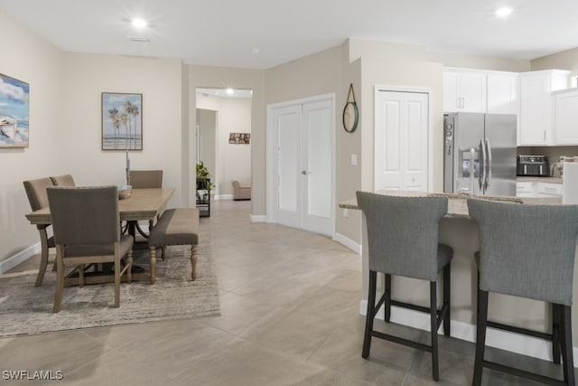 dining area featuring light tile patterned floors