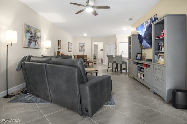 living room featuring tile patterned flooring and ceiling fan