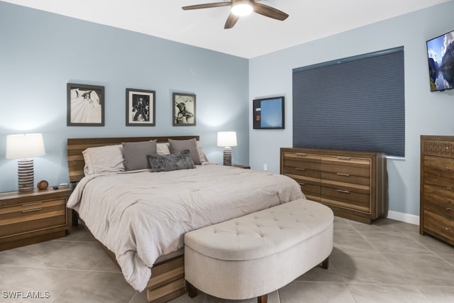 bedroom with ceiling fan and light tile patterned floors