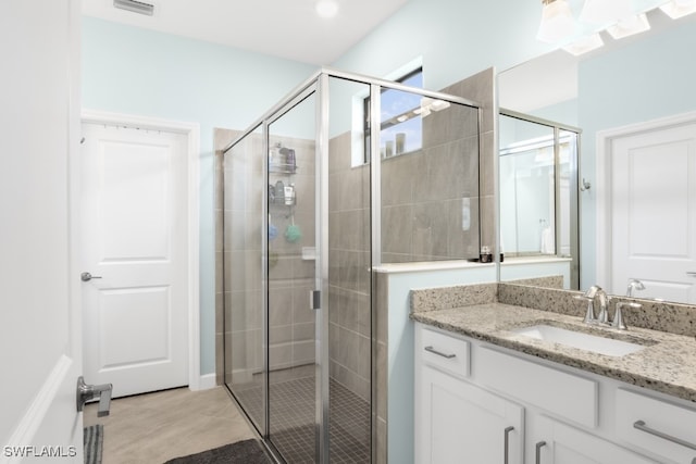 bathroom with vanity, walk in shower, and tile patterned floors